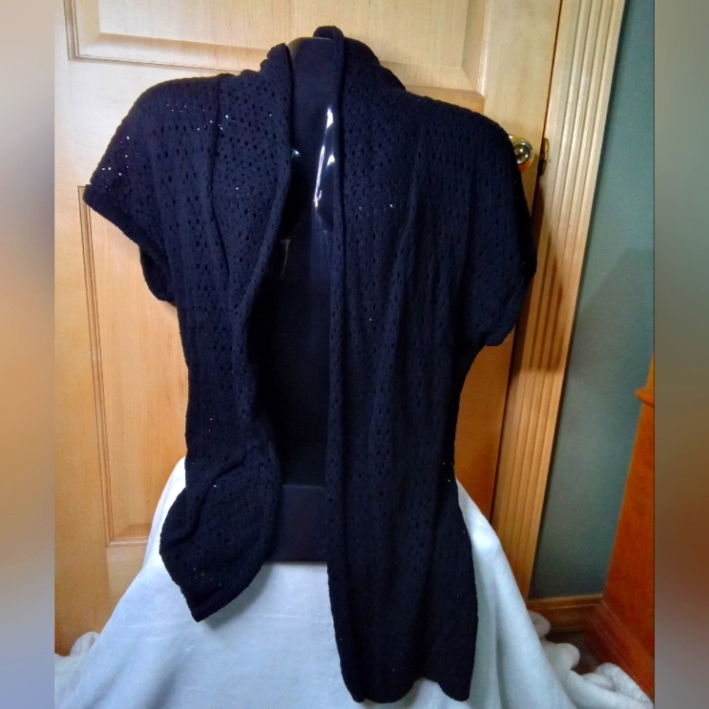 Women's open front, short sleeve, thigh length sweater.